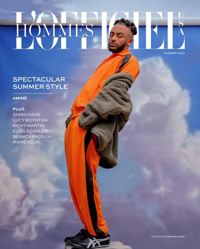 Aminé for the cover of L’Officiel photographed against a cloud backdrop by Steven Taylor