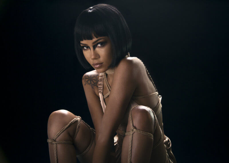 Jhené Aiko photographed by Steven Taylor against a black studio background