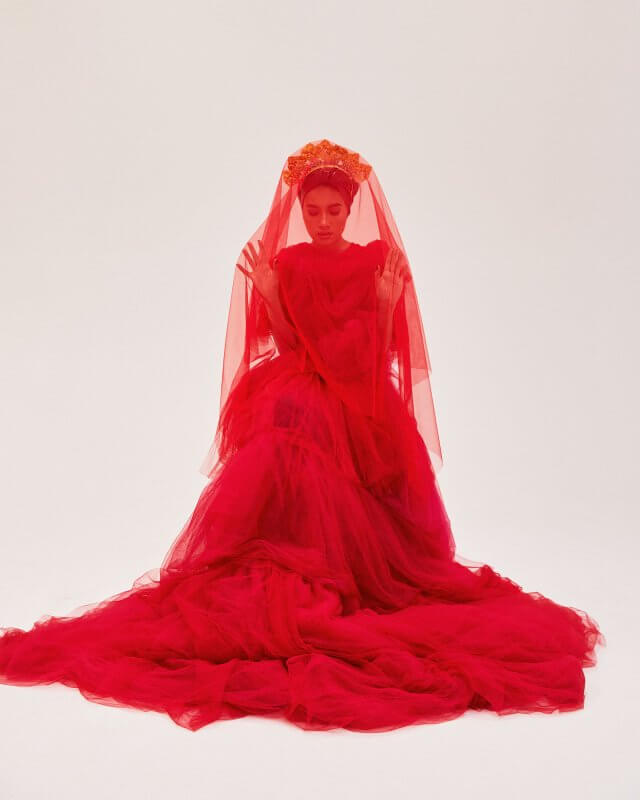 Yuna styled by Ashley Pruitt in a long flowing red gown photographed by Steven Taylor