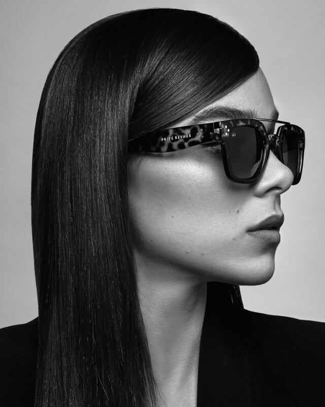 Black and white portrait of Hailee Steinfeld wearing tortoise shell Prive Revaux sunglasses photographed by Steven Taylor